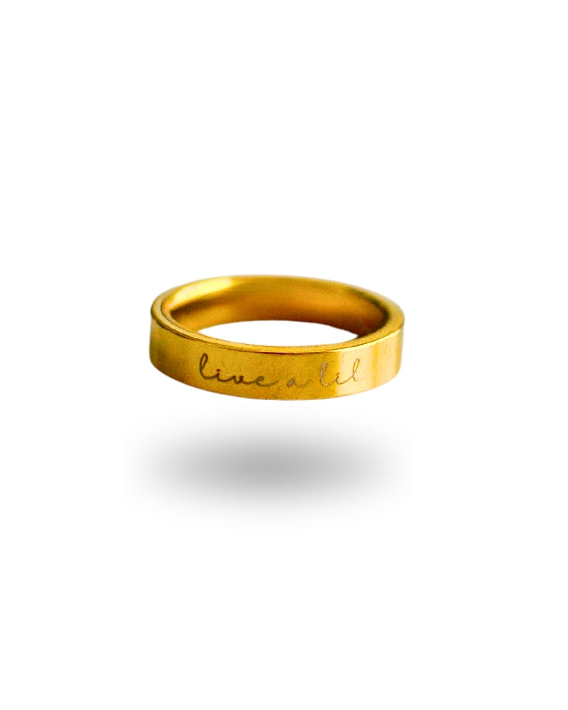 Gold ring with 'live well' engraving on a white background